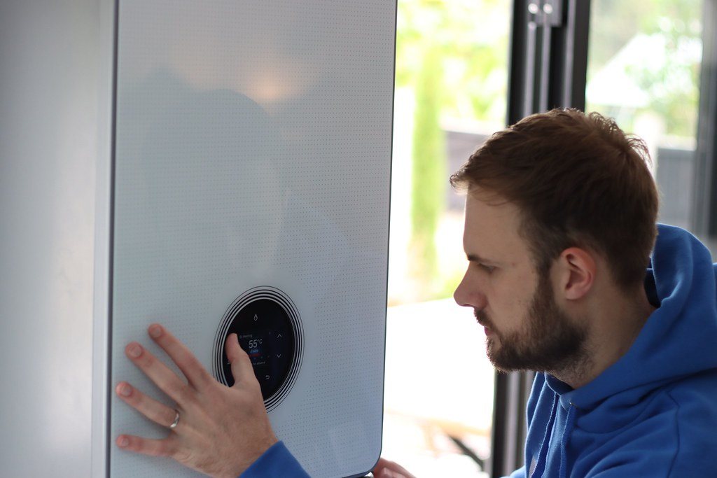An engineer setting up a newly fitted combi boiler